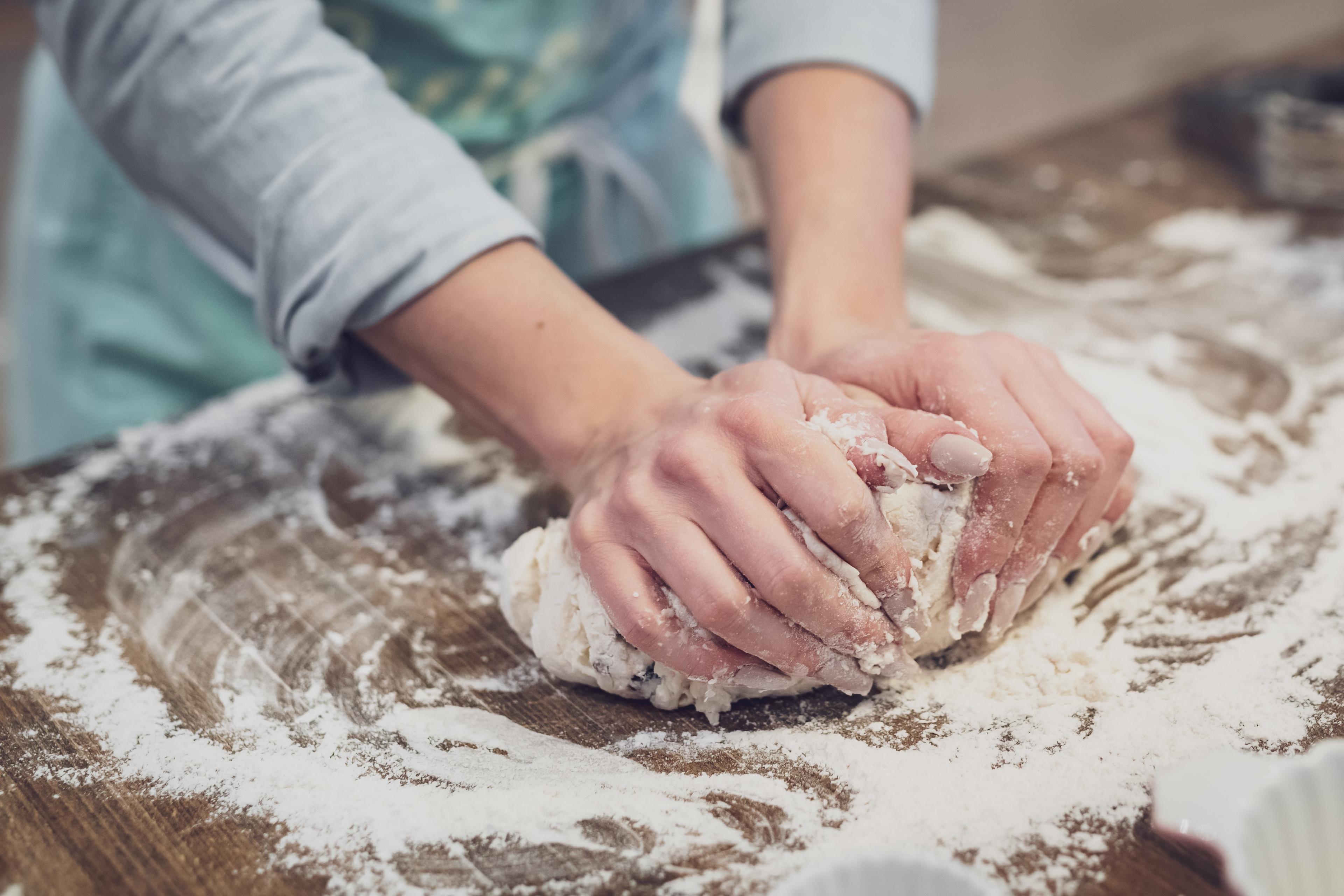 one person kneading dough